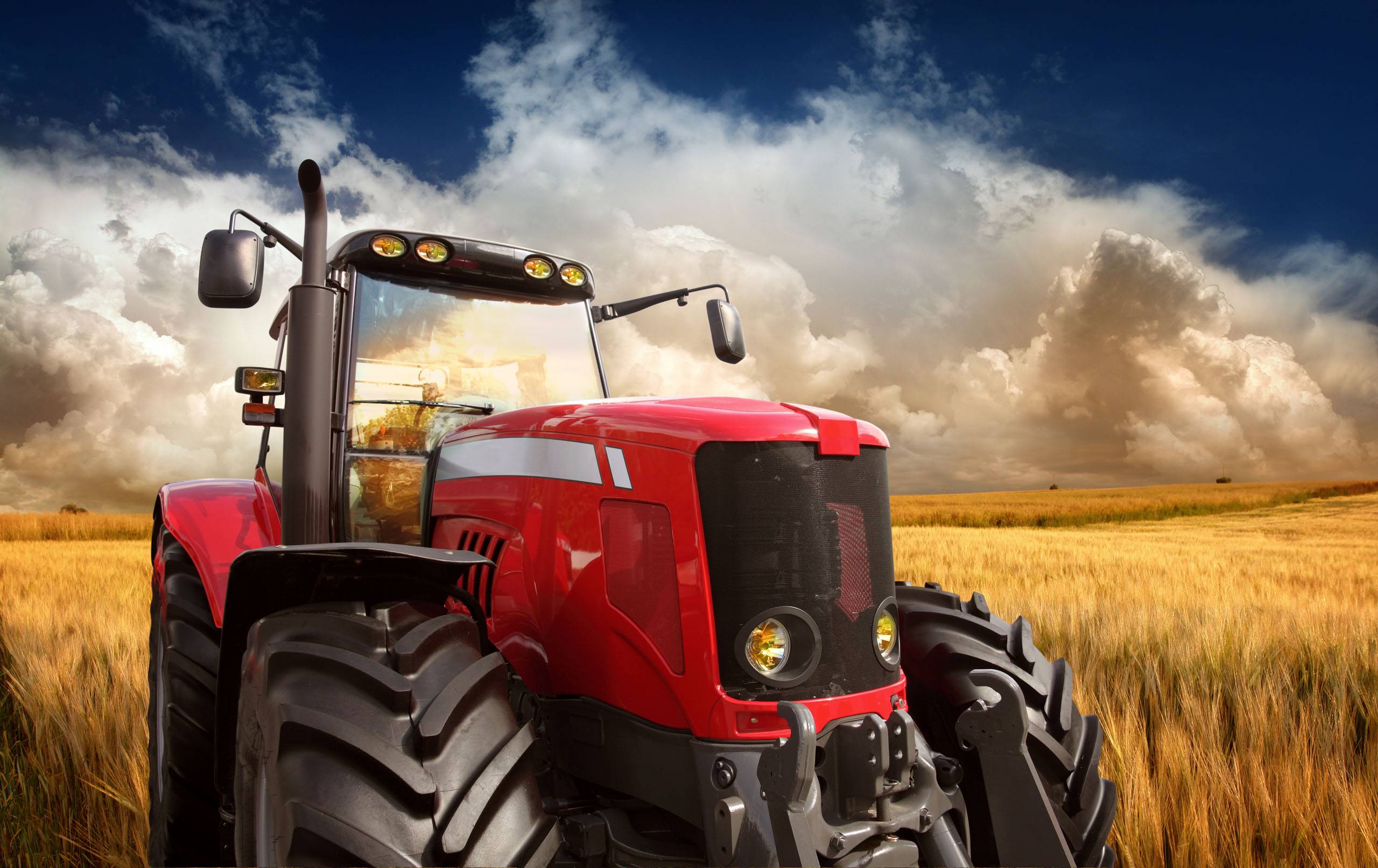 New Modern Tractor on the Barley Field in Sunset Light, Photomontage. See more pictures from my lightbox "On The Farm":